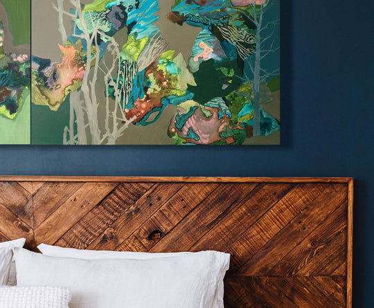 brown and teal abstract landscape painting above bed
